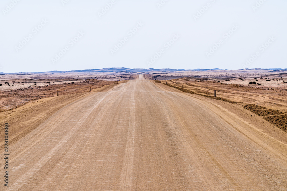 Long gravel road running throught the Kalahari Desert, Namibia