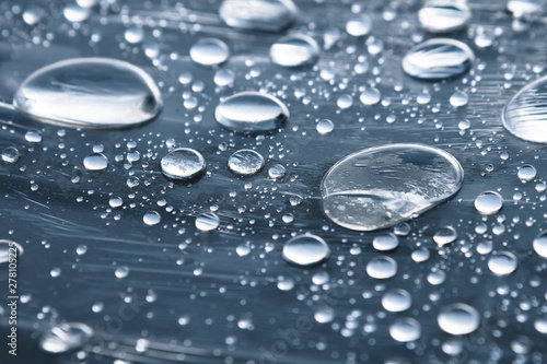 Wallpaper Mural Close-up of raindrops of different sizes on the surface covered with cling film. Moisture weather and humidity concept Torontodigital.ca