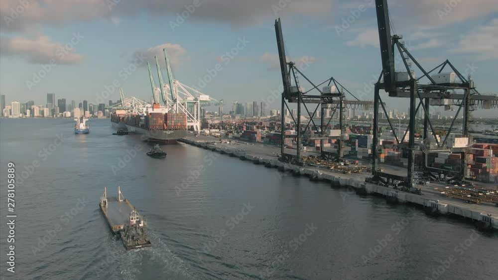 Aerial: Fisher Island car ferry in the Biscayne Bay harbor. In the background is the container port. Miami, Florida, USA. 11 July 2019 Aerial: Fisher Island car ferry in the Biscayne Bay harbor. In the background is the container port. Miami, Florida, USA. 11 July 2019