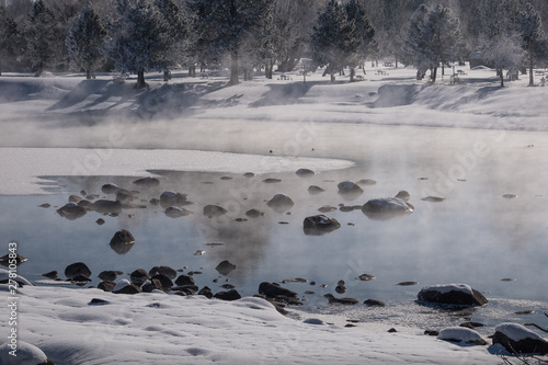 Steam rising from Payette River in snowy Idaho winter photo