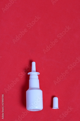 Nasal spray. Against the background of coral color. View from above.
