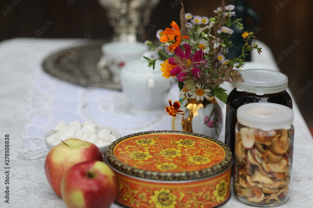 Russian tea ceremony with samovar and sweets and fruits Russian tea ceremony with samovar and sweets and fruits