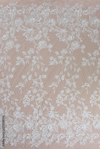 Texture lace fabric. lace on white background studio. thin fabric made of yarn or thread. a background image of ivory-colored lace cloth. White lace on beige background.