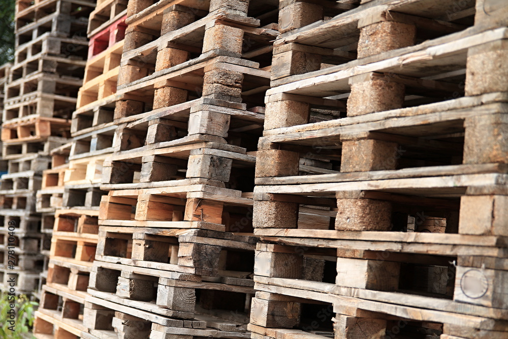 wooden pallets stacked high on top of each other in a companys factory yard in london no people stock photo wooden pallets stacked high on top of each other in a companys factory yard in london no people stock photo