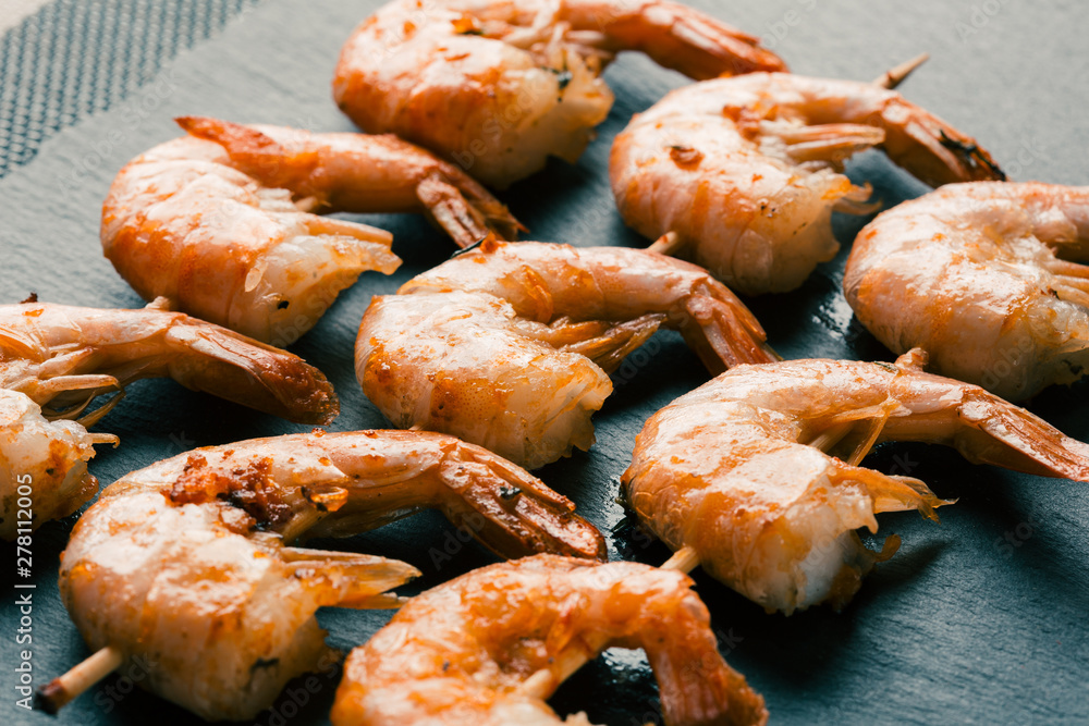 Three rows of fried shrimp skewers side view Three rows of fried shrimp skewers side view