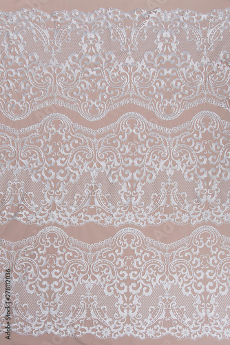 Texture lace fabric. lace on white background studio. thin fabric made of yarn or thread. a background image of ivory-colored lace cloth. White lace on beige background.