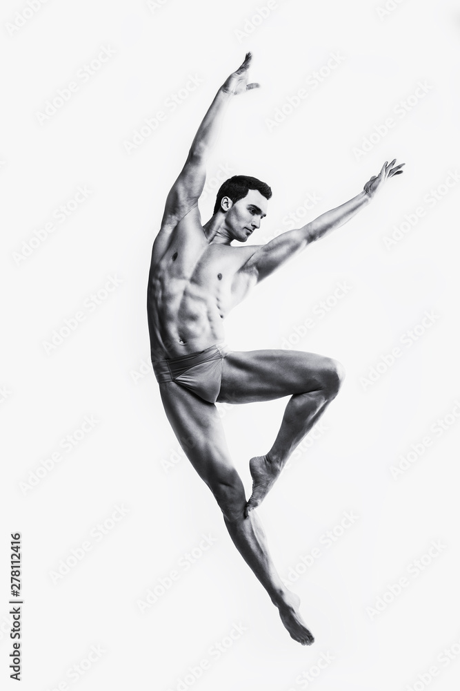 Dance freedom concept. Young handsome ballet man in fly grace pose. Perfect hair & skin. Close up. Studio shot