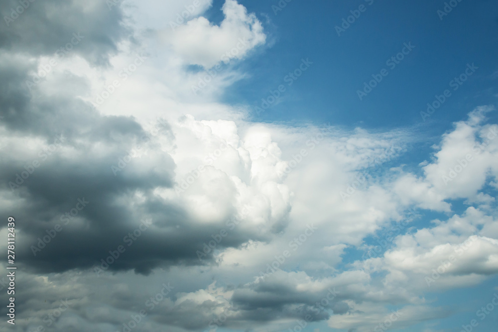 White curly clouds in a blue sky. Sky background