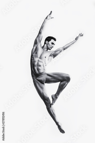 Dance freedom concept. Young handsome ballet man in fly grace pose. Perfect hair & skin. Close up. Studio shot