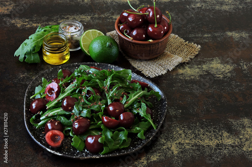 Healthy salad arugula sweet cherry. Raw diet concept. Summer fitness salad.