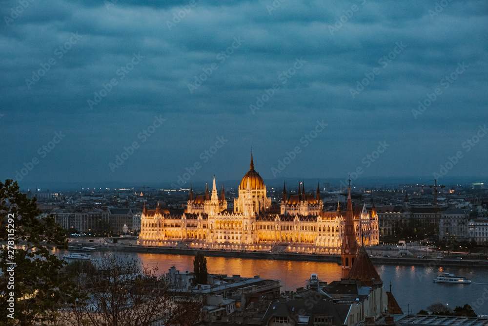 Budapest parliament night yellow illumination river bank