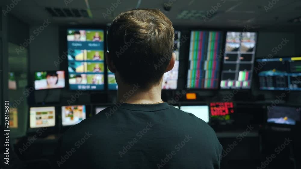 manager oversees the process in TV control room