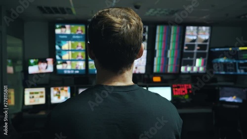 manager oversees the process in TV control room