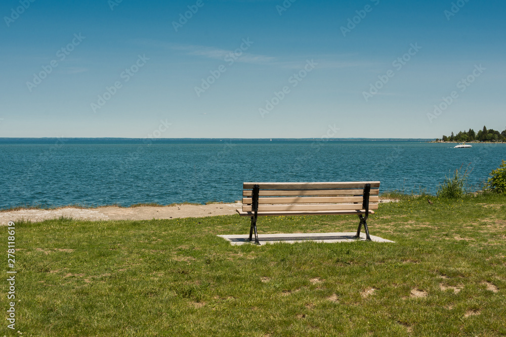 Lonely bench on the shore of a large lake