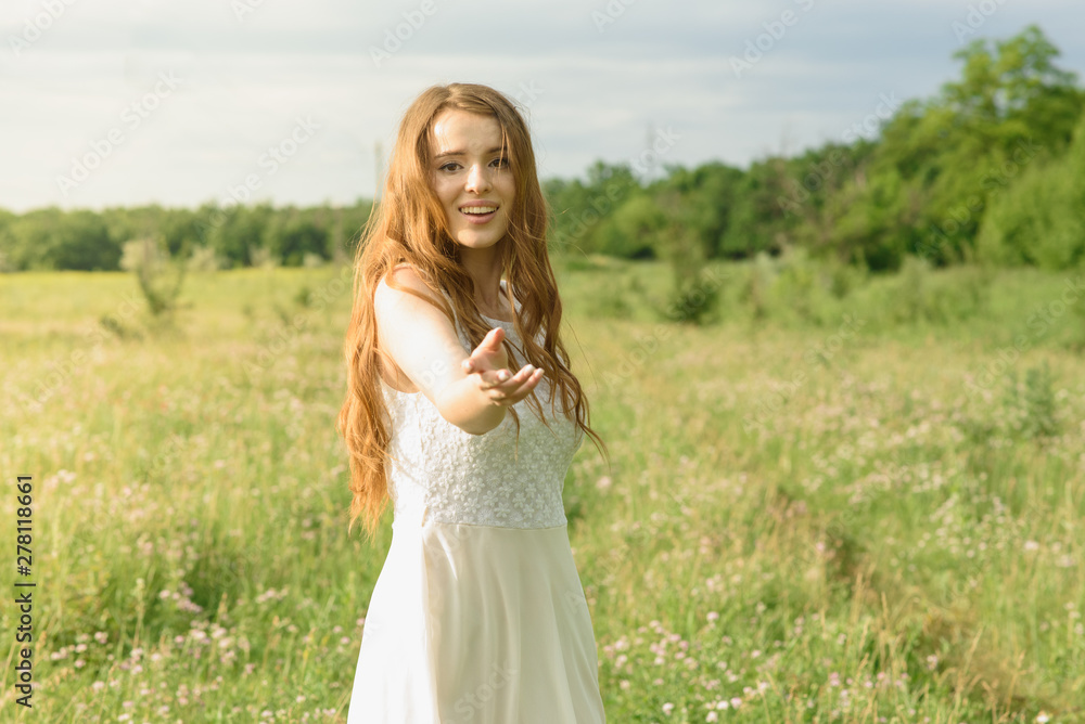 Beautiful and happy young girl running on the green field in a white dress Beautiful and happy young girl running on the green field in a white dress