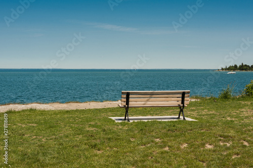 Lonely bench on the shore of a large lake
