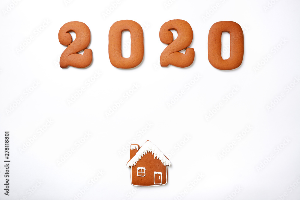 The hand-made eatable gingerbread 2020 inscription and house on white background