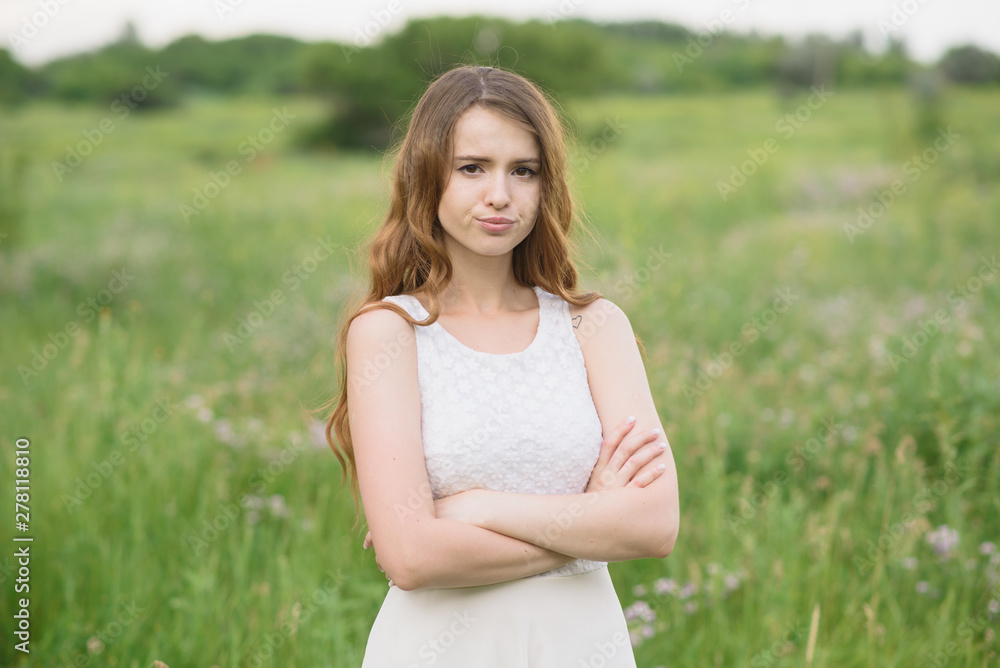Beautiful young girl shows discontent in nature Beautiful young girl shows discontent in nature