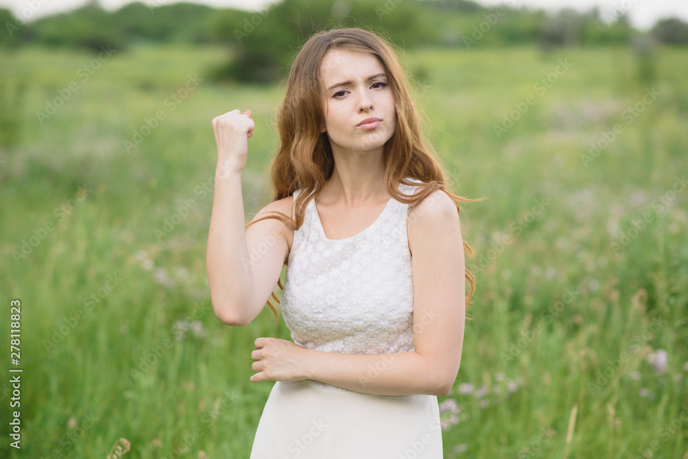 Beautiful young girl shows discontent in nature Beautiful young girl shows discontent in nature