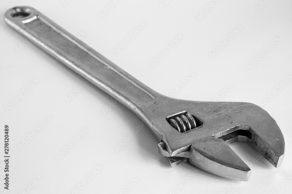A large metal wrench on a white background A large metal wrench on a white background