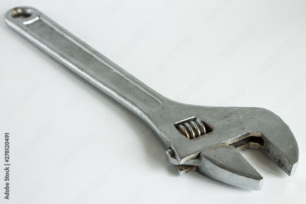 A large metal wrench on a white background A large metal wrench on a white background