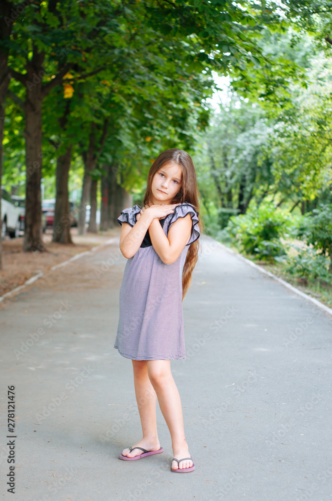 Little cute girl street city lifestyle shooting, summer, smiling at camera Little cute girl street city lifestyle shooting, summer, smiling at camera
