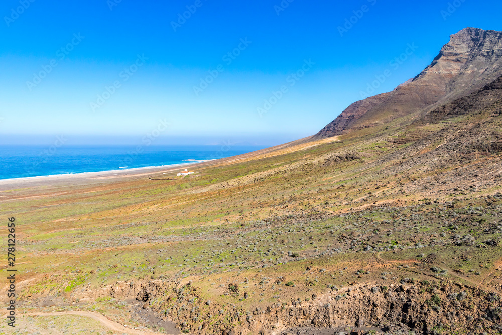 Fototapeta premium Jandia Peninsula, Fuerteventura island, Canary Islands, Spain. Cofete Beach (Playa de Cofete) on the background. Fuerteventura is classic desert island, the oldest island of Canary Islands