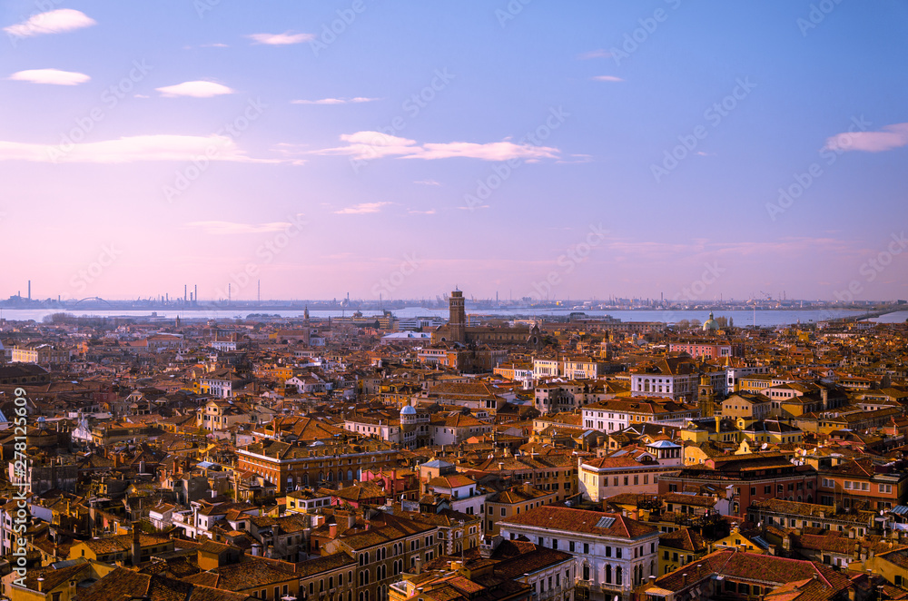 View of a red rooftop horizon, with blue skies over Venice.