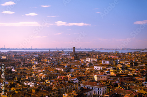 View of a red rooftop horizon  with blue skies over Venice.