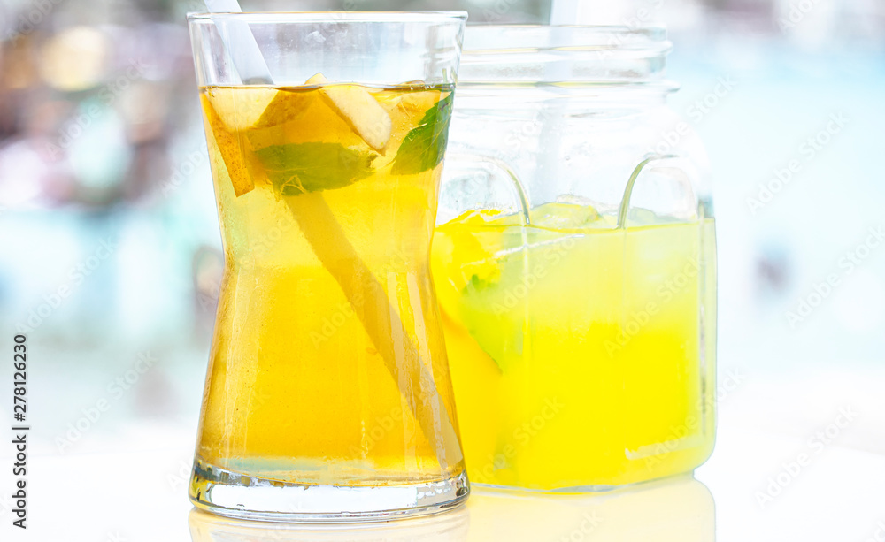 Fresh delicious green tea with apple and lemonade on the sea background.