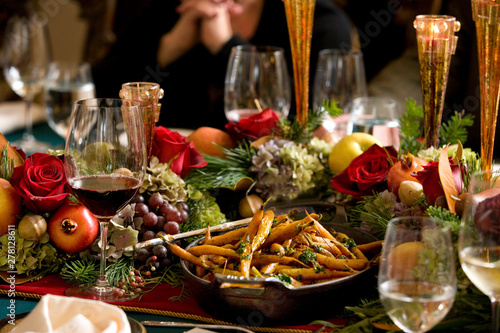 Holiday dinner celebration with wine, appetizers, flowers, in beautiful festive setting
