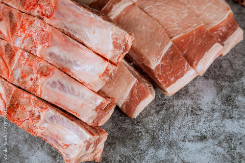 Raw pork chop steak on cutting board.