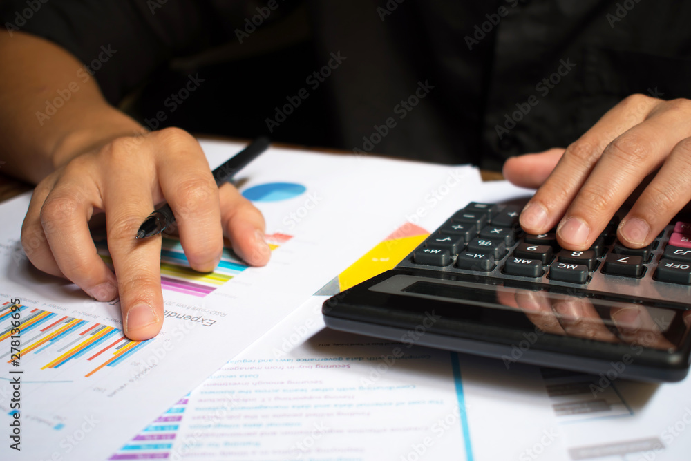 Man hand holding pen and calculating numbers. Man hand holding pen and calculating numbers.
