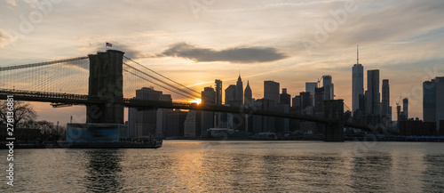 Banner and cover scene of New york Cityscape with Brooklyn Bridge over the east river at the sunset time, USA downtown skyline, Architecture and transportation concept