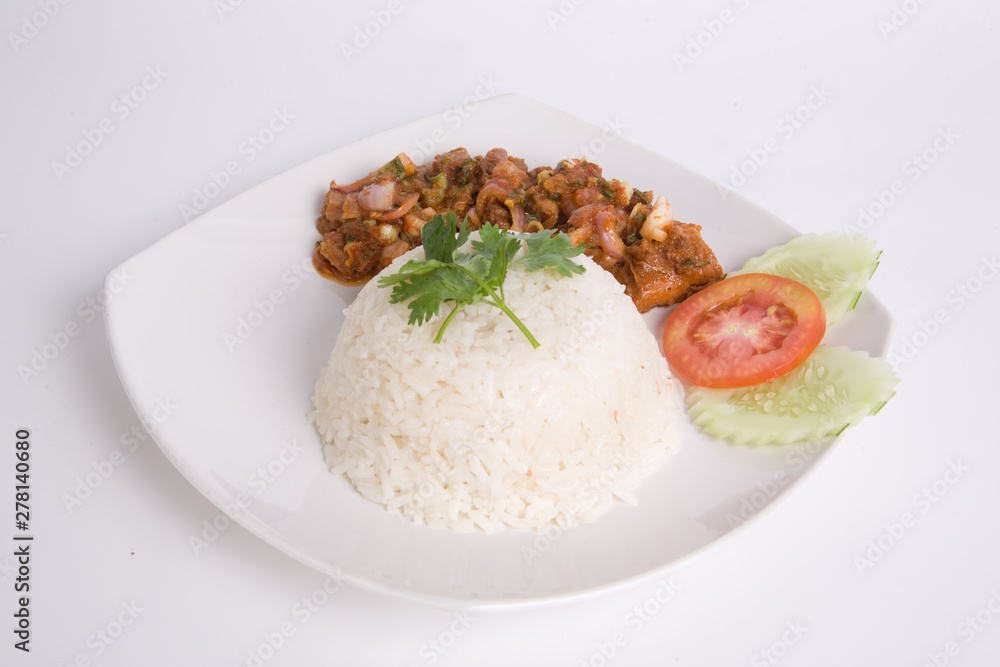 Larb Kai, Thai cuisine spicy salad of roasted chicken with chili sauce steamed rice on white plate Larb Kai, Thai cuisine spicy salad of roasted chicken with chili sauce steamed rice on white plate