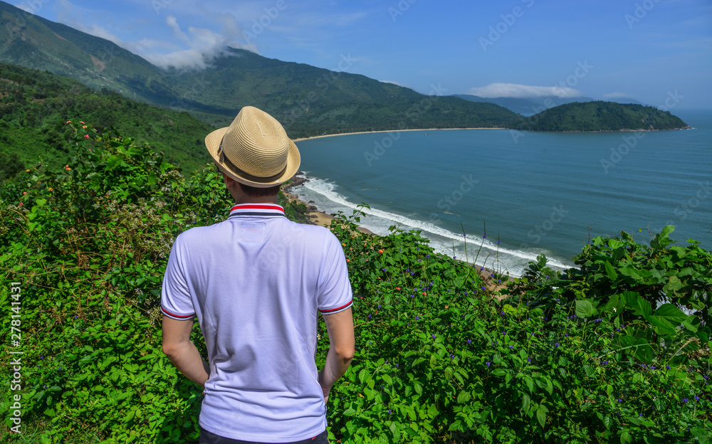 A young man looking at mountain scenery