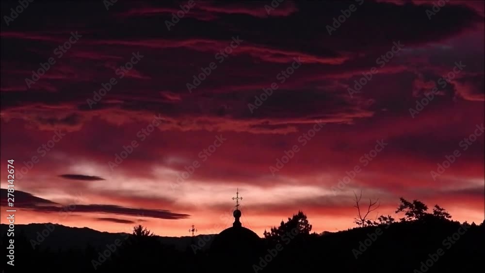 Sunrise with a Cloudy Sky and a Silhouette of a Church Sunrise with a Cloudy Sky and a Silhouette of a Church