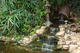 Small artificial waterfall with decorative pond