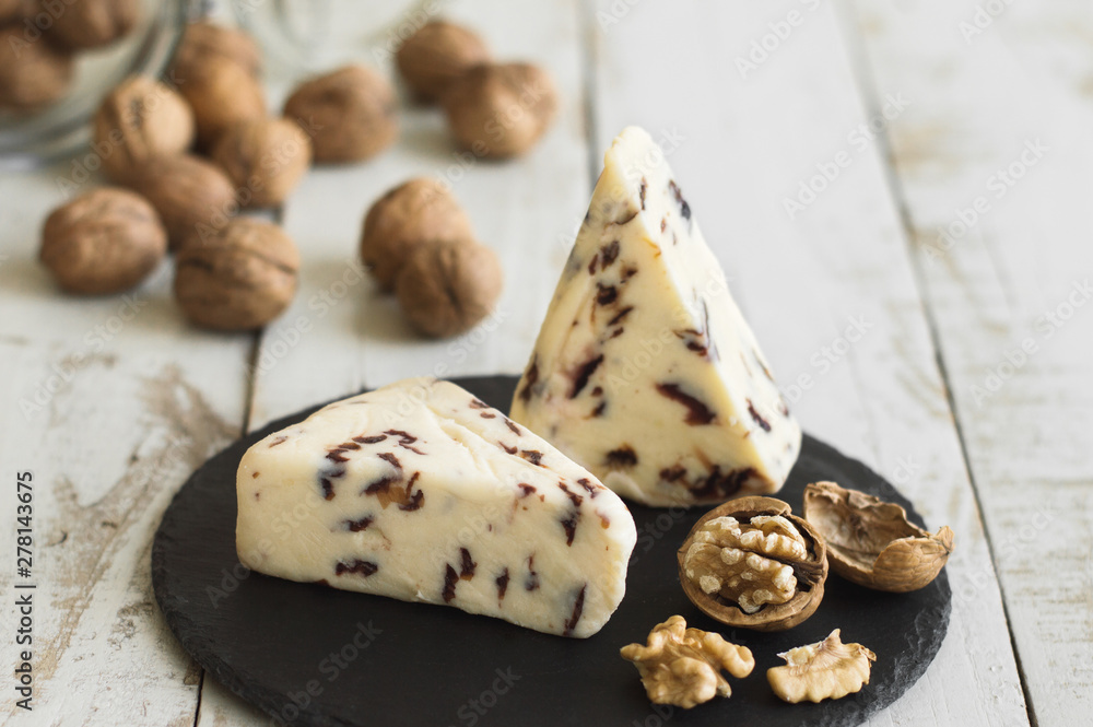 Cranberry cheese served on a slate board with walnut Cranberry cheese served on a slate board with walnut