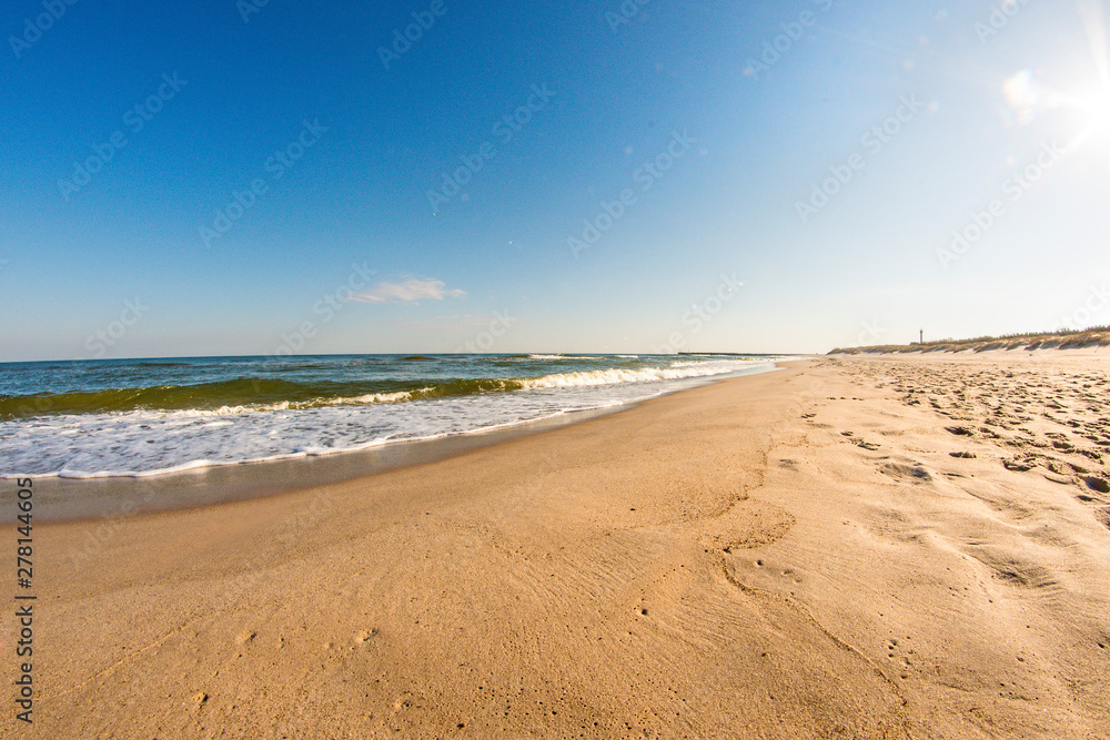 lonesome beach of the Baltic Sea with blue sky and surf lonesome beach of the Baltic Sea with blue sky and surf