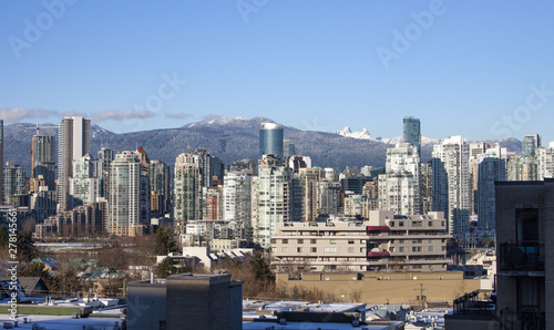 Downtown Vancouver BC Canada skyline with mountains in background on clear blue sky sunny winter day in January 2019