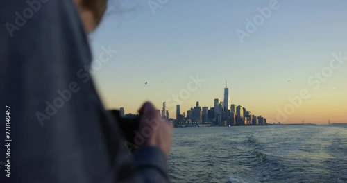 Male Model Photographing Sunset On Hudson River Moving Away From Incredible New York Sunset And Beautiful Skyscrapers and Iconic Skyline In NYC
