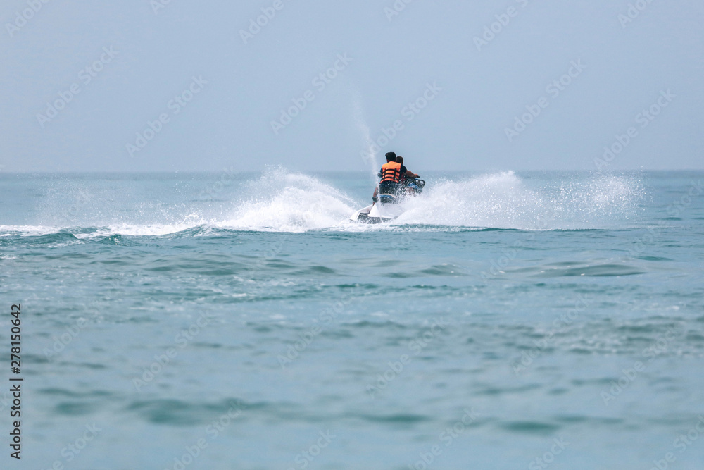 Jet ski at speed in a spray of water Jet ski at speed in a spray of water