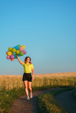 Imagination, happiness, freedom. Beautiful young girl with big bunch of colorful balloons. Birthday, party, dreamer concept
