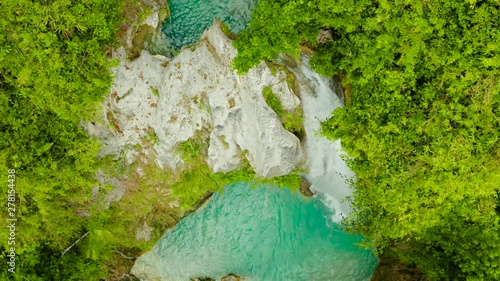 Beautiful waterfall in green forest, top view. Tropical Inambakan Falls in mountain jungle, Philippines, Cebu. Waterfall in the tropical forest. photo