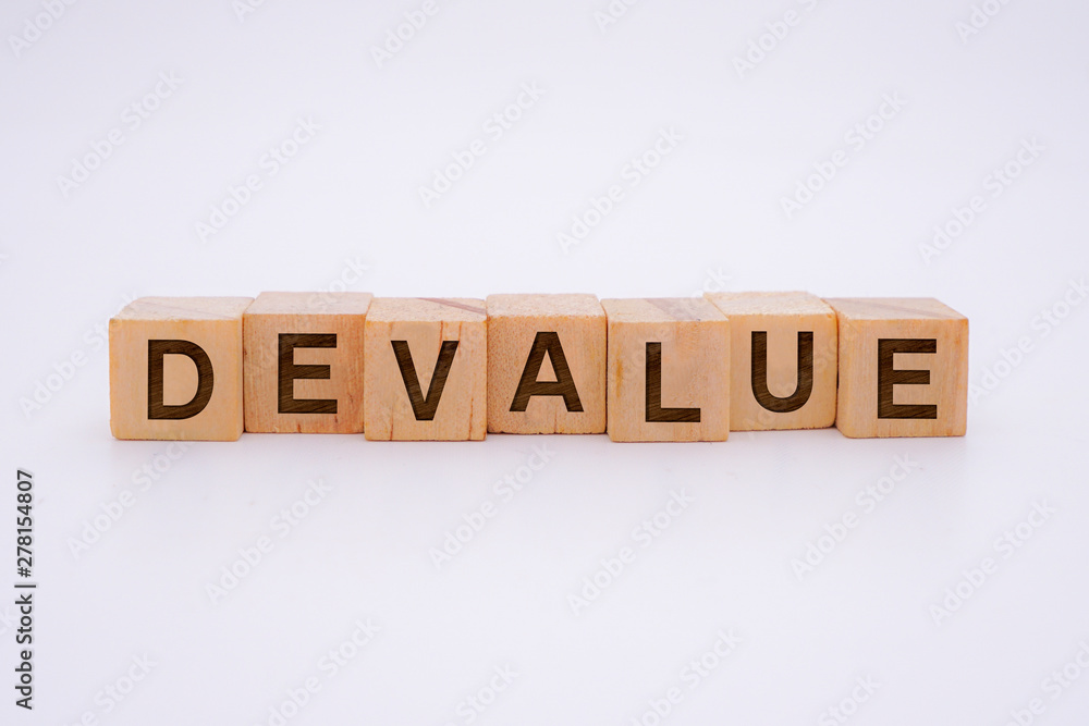 Devalue Word Written In Wooden Cube With White Background Concept Devalue Word Written In Wooden Cube With White Background Concept