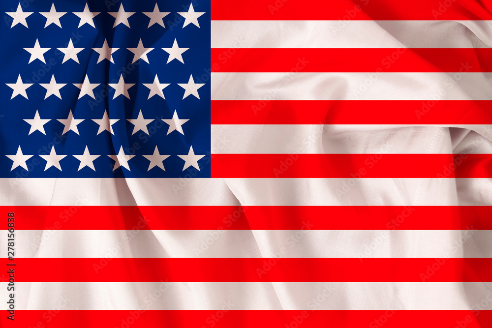 Fototapeta premium beautiful USA national flag on soft silk with soft folds, close-up, copy space