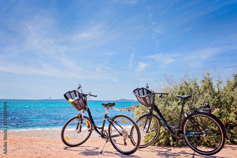 Two bicycles isolated on paradisiacal beach in Mallorca
