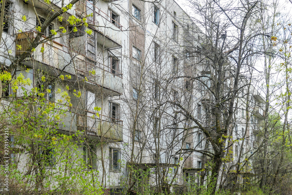 Decaying building in Pripyat, abandoned after the nuclear explosion in Chernobyl, Ukraine. Nature is winning over the concrete, trees are growing . Building is slowly falling apart. Ghost town. Decaying building in Pripyat, abandoned after the nuclear explosion in Chernobyl, Ukraine. Nature is winning over the concrete, trees are growing . Building is slowly falling apart. Ghost town.
