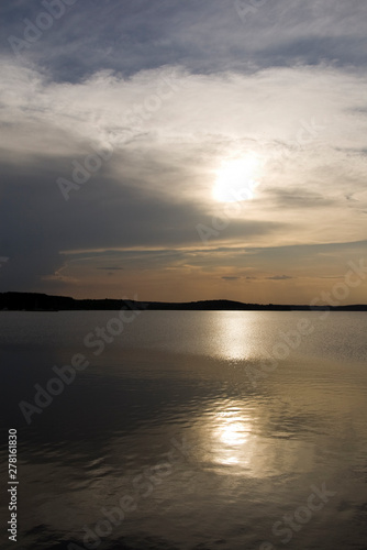 A sunset over the calm lake